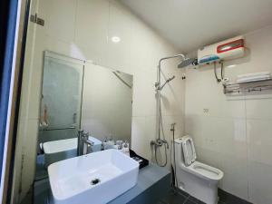 a bathroom with a sink and a toilet at Home Villa TP Giao Lưu in Hanoi