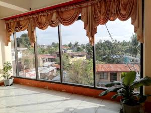 a large window with a view of a city at Constrell Pension House in Tagbilaran City +29 photos