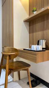 a wooden counter with a wooden stool and a table at Koa Living Semarang in Kalibanteng-kidul +15 photos