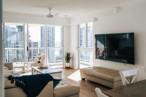 a living room with a large flat screen tv at The Crest Apartments - Main Beach in Gold Coast