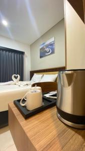 a hotel room with a bed and a table with a blender at Koa Living Semarang in Kalibanteng-kidul