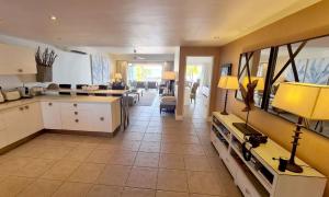 a large kitchen and living room with a couch and a table at Luxury 3BR Direct Beach Access & Pool in Cap Malheureux