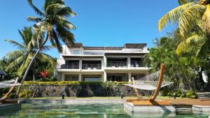 a resort with hammocks and a swimming pool at Luxury 3BR Direct Beach Access & Pool in Cap Malheureux