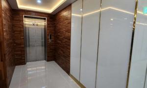 a bathroom with a walk in shower and wooden walls at Gimcheon Sweet Hotel in Kimch'ŏn +29 photos