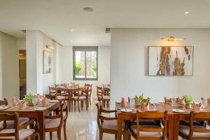 a dining room with wooden tables and chairs at Marine Suites in Colombo