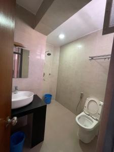 a bathroom with a white toilet and a sink at Pacific Guest House in Kathmandu +25 photos
