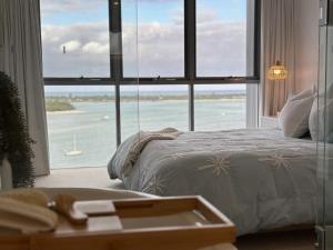 a bedroom with a bed and a large window with a view at Vitamin Sea - Gold Coast luxury on the lagoon in Gold Coast +40 photos