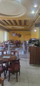 a dining room with wooden tables and chairs at Hotel Bar Restorant Marina in Mjedë