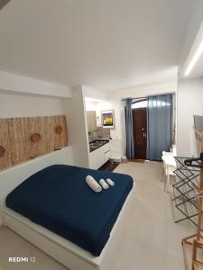 a bedroom with a bed with two white towels on it at Casa vacanze TRINISULA Sicily home in Scicli