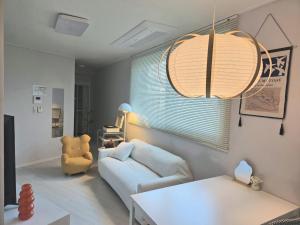 a living room with a couch and a table at SlowNight, Suwon in Suwon