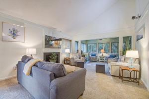 a living room with a blue couch and chairs at West Beach Oceanwoods Cottage 442 in Kiawah Island