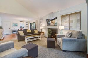 a large living room with couches and a fireplace at West Beach Oceanwoods Cottage 442 in Kiawah Island