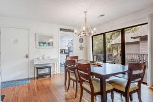 a kitchen and dining room with a table and chairs at West Beach Oceanwoods Cottage 442 in Kiawah Island