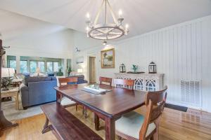 a dining room and living room with a dining table at West Beach Oceanwoods Cottage 442 in Kiawah Island +12 photos