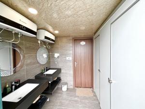a bathroom with two sinks and a mirror at LePont Cat Ba Bungalow in Cat Ba +55 photos