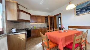 a kitchen and dining room with a table and chairs at La Casa di Ekeko in Vivaro