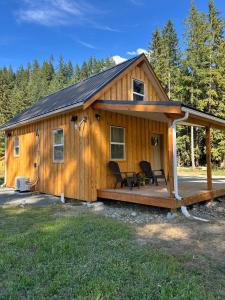 a wooden cabin with a porch and a deck at Mountains Edge Bungalow in Sayward