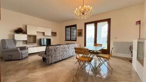 a living room with a table and a couch at La Casa di Ekeko in Vivaro +21 photos