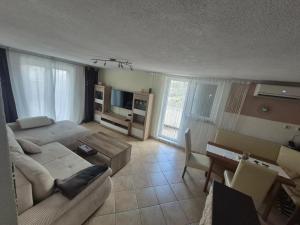 a living room with a couch and a table at Apartmani Mia in Karlobag