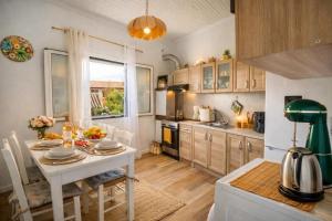 a kitchen with a white table and a dining room at garden home in Gaios