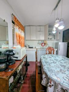 a small kitchen with a table and a microwave at Tagaytay Resthouse 3 big rooms in Ulot