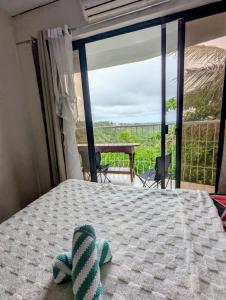 a stuffed animal on a bed in a room with a view at Tagaytay Resthouse 3 big rooms in Ulot
