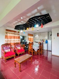 a living room with a table and chairs at Tagaytay Resthouse 3 big rooms in Ulot