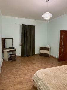 a bedroom with a bed and a dresser and a mirror at Msho Amroc in Aparan +38 photos