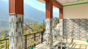 a balcony with a view of the mountains at Dev Niwas in Nākuri