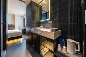 a bathroom with a sink and a toilet and a mirror at Skyline Grand International Hotel - Prime Tianhe City Center Walkable Subway Top Pick for Canton Fair Stunning High Floor Panoramic City View Luxury Guest Rooms in Guangzhou +58 photos