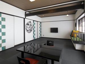 a dining room with a table and a tv at Goyokan in Izu +81 photos