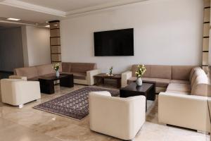 a living room with couches and a flat screen tv at Чынар Отель in Änew
