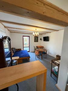 a living room with a bed and a table at Chata Anežka in Stará Ves