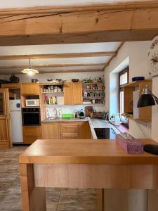 a kitchen with wooden cabinets and a wooden table at Chata Anežka in Stará Ves +44 photos