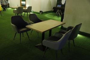 a group of chairs and a table in a room at Grenelle-Indirapuram in Ghaziabad