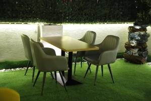 a wooden table and chairs in a yard at Grenelle-Indirapuram in Ghaziabad