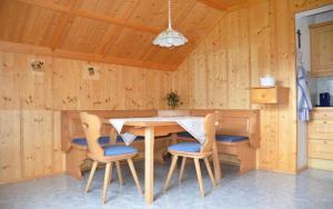 a kitchen with a table and chairs in a room at Pension Max Schraml in Grundlsee