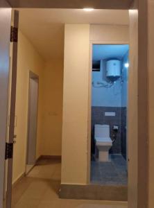 a bathroom with a toilet in a room at Hangout at Nandi Hills in Nandigunda +5 photos