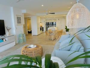 a living room with a couch and a table at Vitamin Sea - Gold Coast luxury on the lagoon in Gold Coast