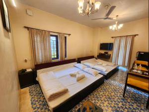 a bedroom with a large bed with pillows on it at Lukochurri in Shānti Niketan