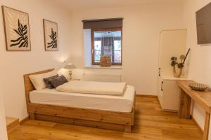 a bedroom with a bed in a room with a window at Chaplin in Kempten
