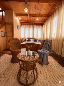 a bedroom with a bed and a table and chairs at The Shivdhaar Estate kud'Patnitop in Kūd