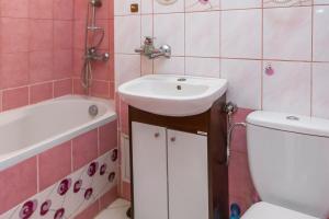 a bathroom with a sink and a toilet at Wspólna Apartment in Warsaw