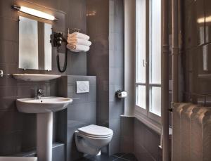 a bathroom with a sink and a toilet at Paris France Hotel in Paris