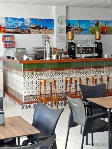 a restaurant with tables and chairs and a counter at Vivienda Rural Alcazaba in Chipiona