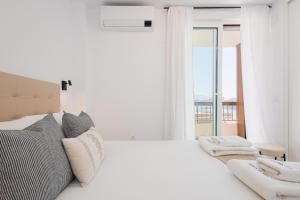 a white bedroom with a large bed and a window at C36 Elegant 2 bdr apt Amazing Views in Málaga