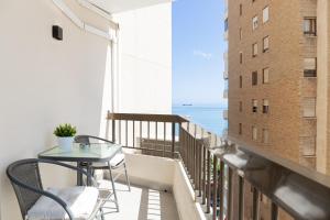 a balcony with a table and chairs and a view of the ocean at C36 Elegant 2 bdr apt Amazing Views in Málaga