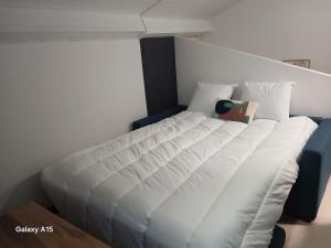 a large white bed in a room at studio coralie in Saint-Flour