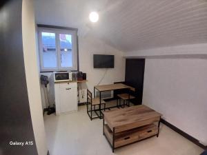 a small room with a table and a microwave at studio coralie in Saint-Flour
