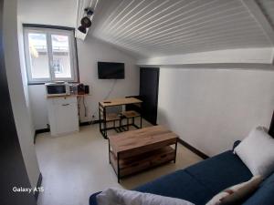 a living room with a couch and a table at studio coralie in Saint-Flour